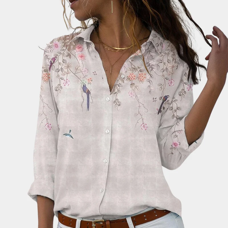 Damblus med blommiga broderier och puffärmar